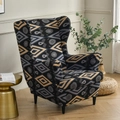 Elastic wingback chair cover in dark grey and gold floral geometric pattern - Bach Geometric Floral