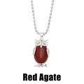 Close-up of a vintage owl pendant with a large red agate stone on a silver bead chain - Red Agate