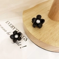 Pair of minimalist black camellia hair clips with pearl centers on a wooden display stand - 114 Black Pearl (1pc)