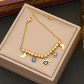 Detailed macro view of golden beads bracelet with blue evil eye and moon enamel charms - Blue Evil Eye Pendants and Gold Crescent Moon (5#)
