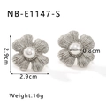 Detailed view of silver flower earrings with pearl centers and brushed metal petals - 18K Gold / Silver (NB-E1147-S)