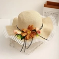 Close-up of beige straw hat featuring lace trim and a large caramel fabric flower - L (58-60cm) / Beige