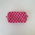 Detail of pink checkerboard knit cosmetic bag with zipper and side handle strap - Pink Plaid