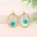 Oval resin pendant with blue dried flowers and golden wire wrap for DIY jewelry - Blue Oval