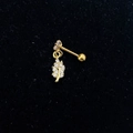 Close-up of golden leaf pendant stud earring with clear zircon inlay on black velvet - Gold-Foliage