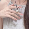 Silver lucky bag pendant necklace with black cord shown on neck for women - Lucky Bag Pendant Necklace