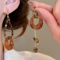 Detailed close-up of asymmetric resin hoops and tiger eye stone beads on gold earrings - Brown-Asymmetric Tiger Eye (21#)