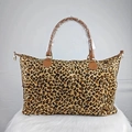 Large leopard print canvas weekender bag with brown PU leather handles on white rug - Leopard Print
