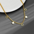 Detail showing gold clover necklace with mother of pearl and hollowed-out pendants - Clover Necklace A703