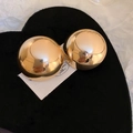 Macro detail of glossy golden dome earrings on a soft black heart velvet surface - Gold Smooth Round (925 Silver Pin)