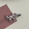 Close-up of pink rhinestone bow hair clip with silver alloy base on a gift card - Silver/Pink Zirconia-Bowknot