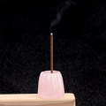 Pink crystal flower incense burner on wooden base with a burning incense stick - Rose Quartz