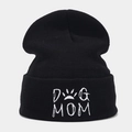 Close-up of white Dog Mom embroidery and paw print on a black cuffed knit beanie hat - DOG MOM / Black