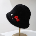 Close-up of black plush bucket hat with red cartoon patch and decorative buttons - Black