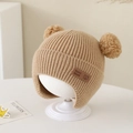 Close-up of baby knit hat with double pom-poms and handmade leather patch detail - Bear Leather Label - Khaki