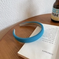 Chic light blue padded sponge headband with non-slip lining on a white book surface - Thickened Padded Fabric Style / Blue