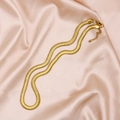 Elegante cadena plana de serpiente de 6 mm bañada en oro sobre tela de seda rosa - Dorado