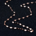 Elegant rose gold copper oval link chain necklace displayed on a luxury black shimmer surface - Lips Chain / Rose Gold
