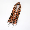 Detail of adjustable leopard print bag strap with orange webbing and silver metal hooks - Orange With Silver Buckle