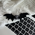 Detailed view of Gothic bat wing hair clip with skull center on a soft knit background - 2# Black Skull Wing Hair Clip