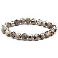 Macro detail of natural 8mm Dalmatian Jasper beaded bracelet on white background - Dalmatian Jasper