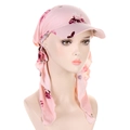 Detail of pink floral turban hat with sun visor and soft fabric side ties for women - Pink Floral