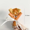 Close-up of 12-15cm mini knitted flower bouquet with orange persimmon and just for you ribbon - Mini Orange Puff Flower