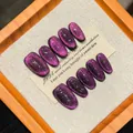 Handmade deep purple cat-eye press-on nails with shimmering glitter on wooden frame - Extra Small (XS)