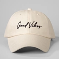 Close-up of Good Vibes black embroidery on a beige canvas baseball cap with fine stitching - Beige