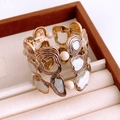 Detail of vintage gold-tone wide cuff bracelet with irregular hammered texture and white inlay - Gold-Beige