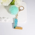Blue resin letter L keychain with mint green pompom and gold lobster clasp for bags - Letter L