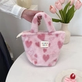 Close-up of pink plush handbag featuring heart patterns and soft faux fur texture - Small Heart Light Pink