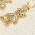 Macro detail of a 14K gold-plated bear pendant set with white cubic zirconia stones - Star Zirconia Bear Necklace (XL2466)