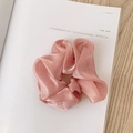 Pink iridescent organza scrunchie with soft satin sheen texture on a magazine - Pearly Satin Pink