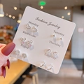 Close-up of 6 pairs of silver earrings set on a white card with weekday labels - E1511-1 Silver Bow Heart Style