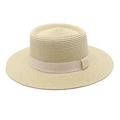 Detailed close-up of a light beige flat-top woven straw hat with a matching ribbon trim - Beige