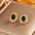 Macro shot of vintage gold-plated oval stud earrings with black stone and pavé zircons - Oval Inlaid / Gold + Black Cat Eye