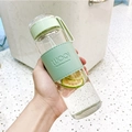 Minimalist glass water bottle with a green leather sleeve and handle for portable use - 16oz / With Tea Infuser / Cyan
