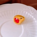 Macro shot of gold-plated ring with a square-cut red stone on a white ceramic plate - 11# Ring - Gold - Red