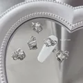 Vue macro de bijoux d'ongles en nœud argenté avec zircon carré, taille 9x11mm sur ongle - #08 Noeud en alliage avec zircon carré