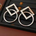 Detail of silver geometric earrings with interlocking square and round metal shapes - Silver (Silver Pin)