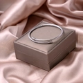 Macro shot of silver cable twisted cuff bracelet on champagne silk and jewelry box - Cable Style (S277-2)