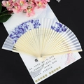 Blue peony folding fan with hollow bamboo ribs and a white silk tassel decoration - Blue Mood White Surface Light Handle