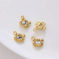 Golden crab pendants with zircon inlay on a white ceramic plate for jewelry making - Gold with White Zirconia Crab