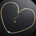 Golden snake chain necklace with blue evil eye pendant arranged in a heart shape - Green
