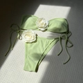 Detail of light green bikini featuring 3D white rose ornaments and side tie bottoms - Light Green