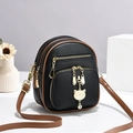 Mini multi-pocket backpack in black pebbled leather with a gold cat pendant - Black and Khaki