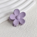 Detail of a matte light purple flower hair claw clip on a clean white display surface - Lavender