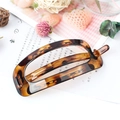 Elegant amber tortoiseshell square hollow hair clip on a minimalist magazine background - Leopard Yellow