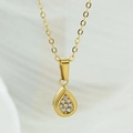 Macro view of gold teardrop pendant necklace featuring micro-pave cubic zirconia stones - Teardrop Pendant